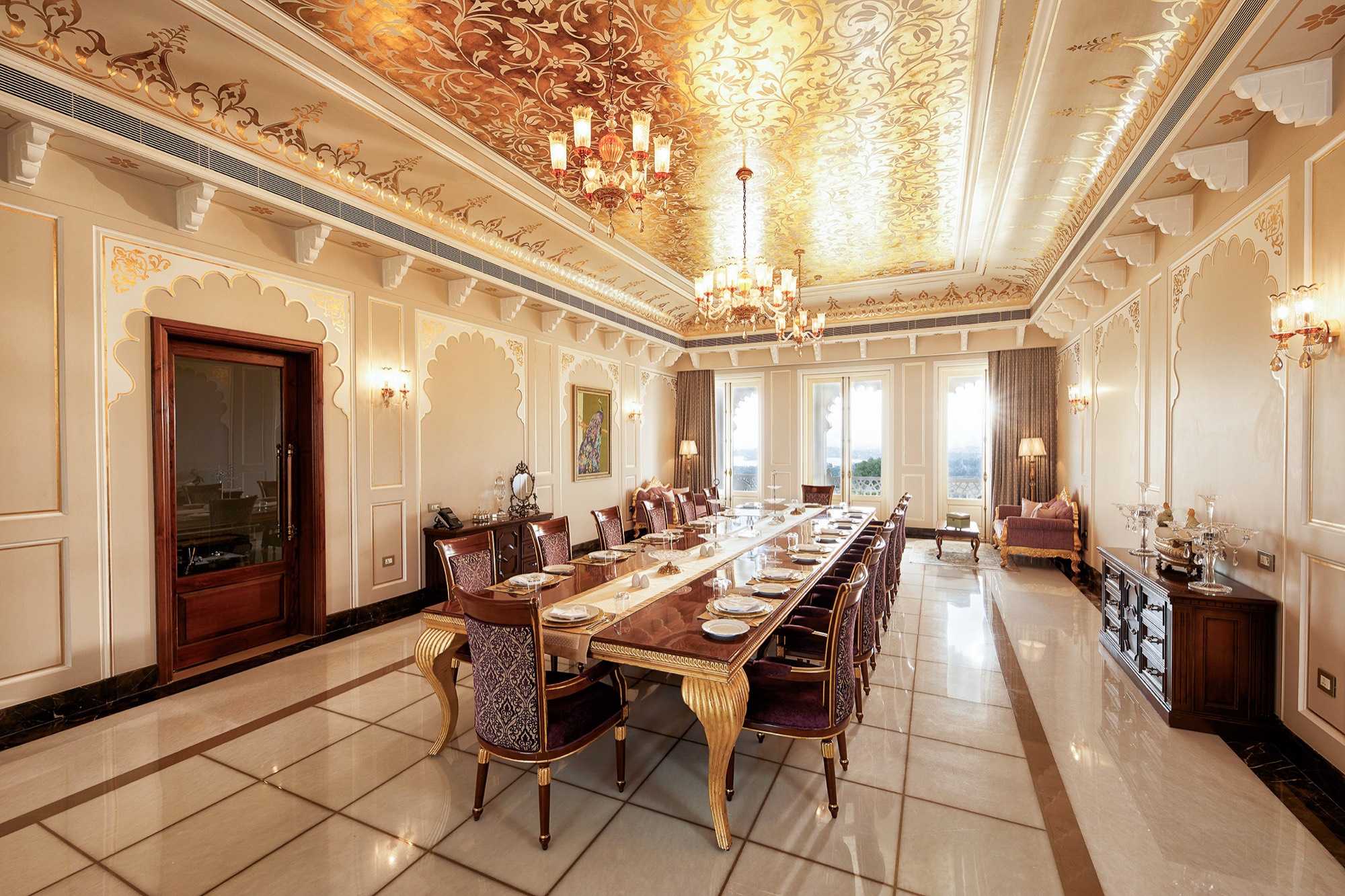 Ornate gilded dining hall with long table and palace ceiling